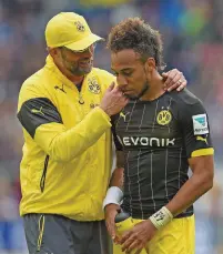  ??  ?? Pierre-Emerick Aubameyang is consoled by manager Jurgen Klopp during their time together at Borussia Dortmund. Right: Celebratin­g after scoring his first Arsenal goal against Everton last weekend