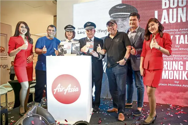  ??  ?? The Allstar (AirAsia staff) captains, Capt Monika (third from left) and ex-pilot and current AirAsia X flight simulator instructor Capt Lim Khoy Hing (fourth from left) at AirAsia’s inflight magazine travel 3Sixty’s 10th year anniversar­y carnival at...