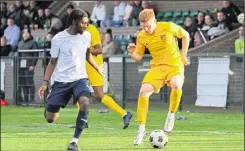  ?? Picture: Paul Davies ?? Kennington (yellow) look for a way past Erith & Belvedere during their 2-1 home defeat