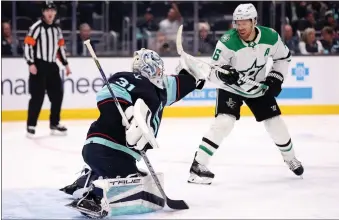  ?? STEPH CHAMBERS — GETTY IMAGES ?? NHL players voted in their annual survey that Joe Pavelski, right, of the Stars is the player who affects the game most around the net. Here, Pavelski, the former Shark, tries to tip a shot past Kraken goalie Philipp Grubauer.