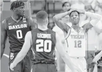  ?? Eric Gay / Associated Press ?? While the Bears’ Jo Lual-Acuil Jr., left, ended up with the last laugh after his game-winning basket in the second overtime, it was a tough loss for Kerwin Roach (12) and the Longhorns.