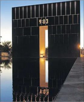  ??  ?? Lights glow on the west gate of the Oklahoma City National Memorial, causing its image to be seen in the nearby reflecting pool.[ ARCHIVE PHOTO BY NATE BILLINGS/ THE OKLAHOMAN]