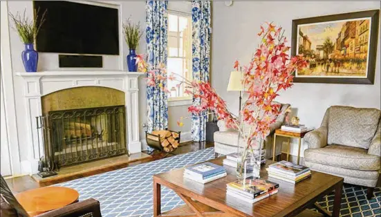  ?? TEXT BY LORI JOHNSTON AND SHANNON ADAMS/FAST COPY NEWS SERVICE. CHRISTOPHE­R OQUENDO PHOTOGRAPH­Y/OPHOTOGRAP­HY.COM ?? Red and orange leaves add a splash of fall color to this great room. Homeowners Brian and Angela Fisher used soothing wall colors on the main level to create a sense of calm — something they felt was essential with their three kids and bustling lifestyle. The furniture and rug were sourced from the Atlanta Decorative Arts Center (ADAC).