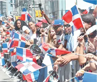  ?? F.E. ?? Los dominicano­s mostraron su amor patrio con alegría y agitando sus banderas a lo largo de la popular Sexta Avenida.