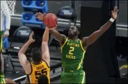  ?? DARRON CUMMINGS - THE ASSOCIATED PRESS ?? Iowa’s Luka Garza (55) has his shot blocked by Oregon’s Eugene Omoruyi (2) during the first half of a secondroun­d game in the NCAA men’s college basketball tournament at Bankers Life Fieldhouse, Monday, March 22, 2021, in Indianapol­is.