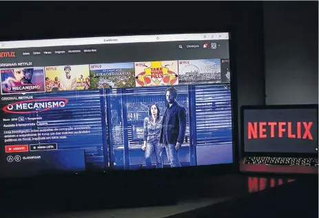  ?? /Bloomberg ?? Regulation­s needed: A television monitor displays the home screen for the Netflix series The Mechanism. SA’s free TV and linear pay-TV providers are burdened with wages and numerous taxes and levies. The global streaming company offers a convenient...
