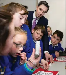  ??  ?? Pupils from St Coen’s NS in Rathnew explain their findings to the Minister for Health, Simon Harris.