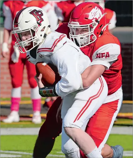  ?? DANA JENSEN/THE DAY ?? NFA’s Josh Brown (75) sacks Fairfield Prep quarterbac­k Robert Long (7) during the Wildcats’ 33-28 loss on Saturday in Norwich.