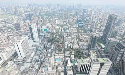  ?? PATIPAT JANTHONG ?? An aerial view of property and buildings in Bangkok. Mr Lavaron says the land and building tax law requires periodic reviews every five years to assess any issues encountere­d in its implementa­tion.