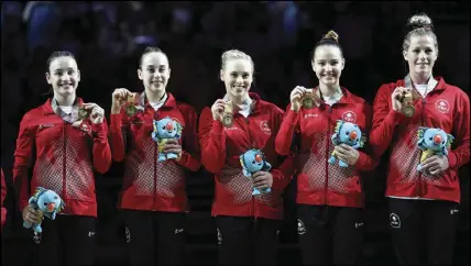  ?? AP PHOTO ?? Canada’s (from left) Shallon Olsen, Isabela Onyshko, Ellie Black, Jade Chrobok and Brittany Rogers celebrate with their medals after winning the women’s team artistic gymnastics competitio­n.