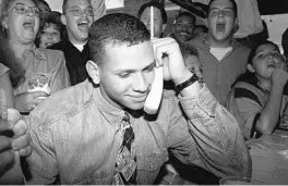  ?? MARTA LAVANDIER/ASSOCIATED PRESS ?? A young high-school baseball star, Alex Rodriguez of Miami, listens as the Seattle Mariners ask him to join their team amid cheers from his mother, left, and friends on June 3,1993.