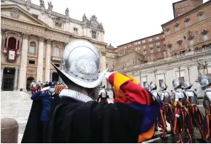  ?? The Associated Press ?? Swiss Guards march in front of St. Peter’s Basilica at the Vatican on Saturday.