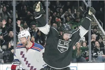  ?? Luis Sinco Los Angeles Times ?? KINGS CENTER Anze Kopitar celebrates after scoring a goal against the New York Rangers in March. Kopitar was named the team captain during the off-season, an honor that was taken from Dustin Brown.