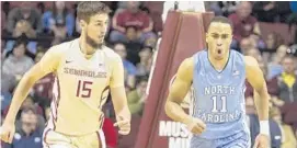  ?? MARK WALLHEISER/ASSOCIATED PRESS ?? North Carolina forward Brice Johnson, right, reacts after dunking over Florida State center Boris Bojanovsky on Monday.