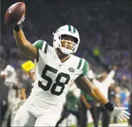  ?? Rick Osentoski / Associated Press ?? Jets linebacker Darron Lee celebrates a 36-yard pick six at Detroit on Monday night.