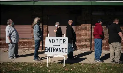  ?? Photograph: Wong Maye-E/AP ?? Voters wait in line outside a polling center on election day in Kenosha, Wisconsin, on 3 November 2020.