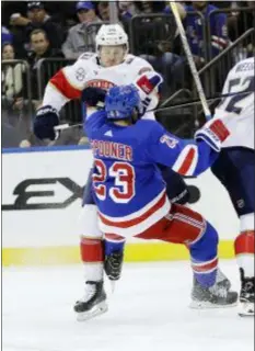  ?? FRANK FRANKLIN II — THE ASSOCIATED PRESS ?? Florida’s Jared McCann (90) checks the Rangers’ Ryan Spooner (23) during the second period on Tuesday in New York. The Rangers won, 5-2.