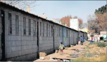  ??  ?? UPGRADES: A boy is seen making his way home from a nearby store at Thokoza Hostel, which the municipali­ty is planning to refurbish.