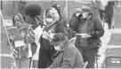  ?? ANGELA PETERSON / MILWAUKEE JOURNAL SENTINEL ?? People stand and sit in an area for those needing additional voting assistance at Marshall High School on April 7.