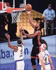  ?? Douglas P. DeFelice / Getty Images ?? The Heat’s Jimmy Butler shoots the ball during the first half against the Los Angeles Lakers during Game 3 of the NBA Finals on Sunday in Lake Buena Vista, Fla.