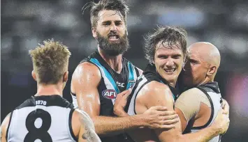  ?? Picture: GETTY ?? WINNERS: Port Adelaide’s Charlie Dixon and Jared Polec celebrate a goal last night.