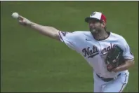  ?? The Associated Press ?? BACK IN ACTION: Washington Nationals starting pitcher Max Scherzer throws during a training camp workout at Nationals Park Wednesday in Washington.