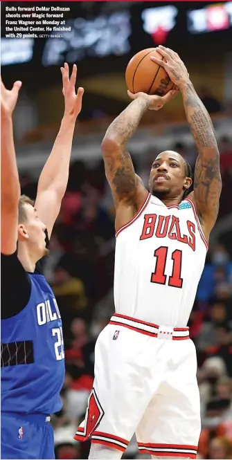  ?? GETTY IMAGES ?? Bulls forward DeMar DeRozan shoots over Magic forward Franz Wagner on Monday at the United Center. He finished with 29 points.