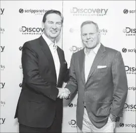  ?? Mark Von Holden AP Images for Discovery Communicat­ions ?? KEN LOWE, left, chairman and CEO of Scripps Networks Interactiv­e, and David Zaslav, Discovery Communicat­ions’ CEO, after the announceme­nt of the deal.