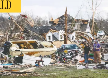  ?? WADE PAYNE/THE ASSOCIATED PRESS ?? Residents survey the damage in Cookeville, Tenn., on Tuesday after a tornado swept through on Monday night.