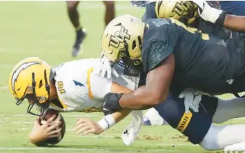 ?? STEPHEN M. DOWELL/ORLANDO SENTINEL ?? UCF defensive tackle Ricky Barber tackles Kent State quarterbac­k Michael Alaimo during last season’s opener at FBC Mortgage Stadium. Barber is returning to the Knights for his final season after suffering through an injury-plagued 2023-24 campaign.