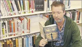  ?? LyNN CURwIN/TC MedIa ?? Chris Wildbore settles down with a book on the paranormal in the adult non-fiction corner where the sprit of a child often frequents.