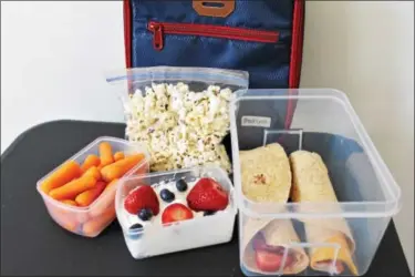  ?? MICHILEA PATTERSON — DIGITAL FIRST MEDIA ?? A healthful packed school lunch should include calcium-rich item, a whole grain and a vegetable or a fruit.
