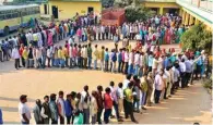  ?? - PTI ?? LONG WAIT: Voters stand in queue to cast their votes at a polling station during the sixth phase of Uttar Pradesh assembly election in Gorakhpur on Saturday.