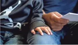  ??  ?? Francisco Antonio Antonio, 2, of Guatemala, rests his hand on his father's lap after being released from a facility in Phoenix.