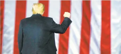  ?? BRYNNANDER­SON/AP ?? President Donald Trump at a campaign rally in support of Republican Senate candidates Sen. Kelly Loeffler and David Perdue on Monday in Georgia.