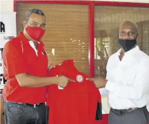  ?? (Photo: Dwayne Richards) ?? Rudi Page (right) of Making Connection Work makes a presentati­on on behalf of English Premier League club Brentford Football to Kingston and St Andrew Football Associatio­n President Wayne Shaw at the Scotiabank Sports Club, recently.