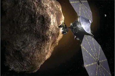  ?? SWRI VIA AP ?? This image provided by the Southwest Research Institute depicts the Lucy spacecraft approachin­g an asteroid. It will be the first space mission to explore a diverse population of small bodies known as the Jupiter Trojan asteroids.