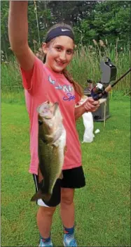  ?? SUBMITTED PHOTO ?? A young lady from Alaska shows her very first fish she ever caught.