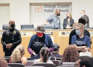  ?? RICARDO RAMIREZ BUXEDA/ORLANDO SENTINEL ?? Women wearing Moms for Liberty shirts attend the Orange County School Board meeting Oct. 26.