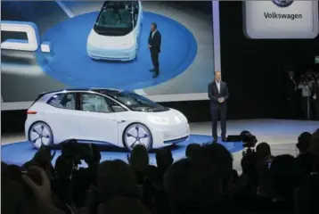  ?? MICHEL EULER, THE ASSOCIATED PRESS ?? Volkswagen chair Herbert Deiss introduces the new Volkswagen I.D. concept car, a battery-powered hatchback with a top range of 600 kilometres on a fully charged battery, at the Paris auto show Thursday.