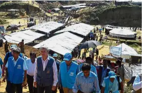  ??  ?? Dire times: UN High Commission­er for Refugees Filippo Grandi (second from left) visiting Bangladesh’s Kutupalong refugee camp for Rohingya. — AFP