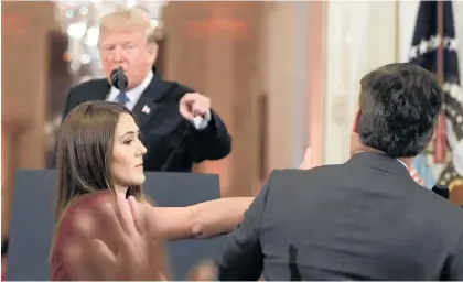  ?? Photo / AP ?? Donald Trump tells Jim Acosta, “That’s enough,” as the intern reaches for the microphone in his hand.