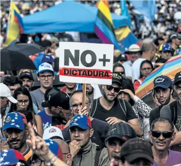  ?? JUAN BARRETO/GETTY IMAGES ?? Venezuelan opposition activists protest the government of President Nicolas Maduro in Caracas on May Monday. Thousands of Venezuelan­s participat­ed in a seventh week of anti-government demonstrat­ions.