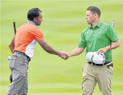  ??  ?? SSP Chawrasia, left, and Andrew Martin shake hands on the 18th green after the third round yesterday.