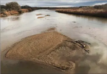  ?? AP PHOTO/SUSAN MONTOYA BRYAN ?? In this Feb. 22 file photo, sandbars fill the Rio Grande north of Albuquerqu­e, N.M. Drought is stiffening its hold across the American Southwest as extreme conditions spread from Oklahoma to Utah. The federal drought map released Thursday shows dry...