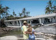  ??  ?? Surveying their broken home in the Keys