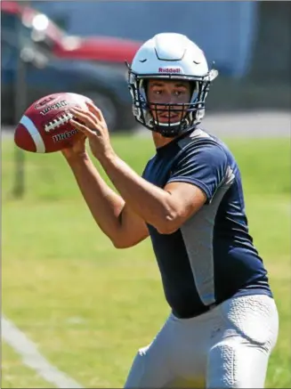  ?? THE MORNING JOURNAL FILE ?? Lorain quarterbac­k Justin Sturgill warms up on the first day of practice. Sturgill says he needs to step up as a team leader.