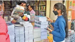  ?? — R. PAVAN ?? A girl purchases notebooks ahead of the beginning of the new academic year, at Koti on Tuesday.