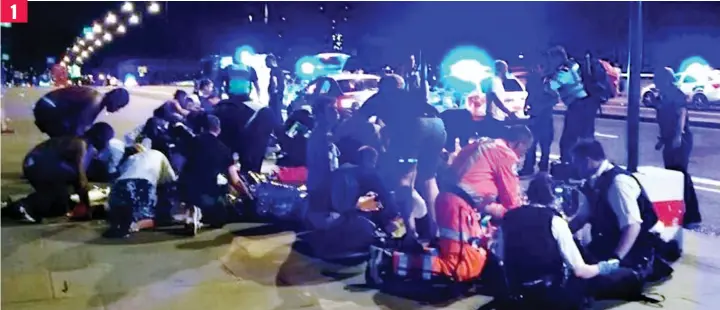  ??  ?? 1 Carnage: Bystanders and emergency services including paramedics deal with the victims after the terrorists’ van ploughed into pedestrian­s on London Bridge