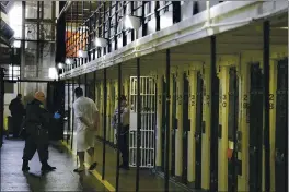  ?? ASSOCIATED PRESS ARCHIVES ?? An inmate is led out of his death row cell at San Quentin State Prison. A state official said California has sent about $400million in unemployme­nt benefits to state prison inmates.